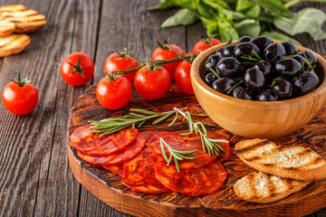 Spanish traditional chorizo sausage with fresh herbs, olives.