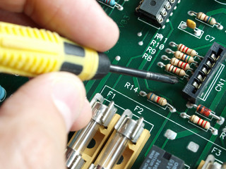 engineer working on electronic circuit close up detail