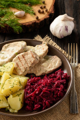 Grilled pork tenderloin in sour cream sauce with dill served with potatoes and beetroot salad.