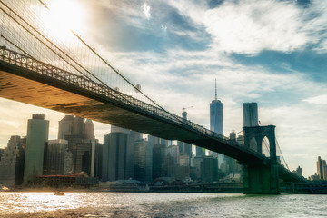 Fototapeta premium Brooklyn Bridge in New York City at sunset. Vivid splittoned image.