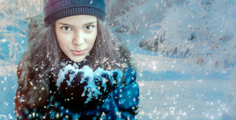 girl blowing on a snowflake