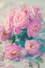 Close-up floral composition with a pink roses .Many beautiful fresh pink roses on a table.