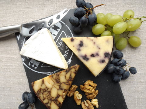 Cheeseboard. Brie cheese, seasoned in Porter cheese and cheese with blueberries