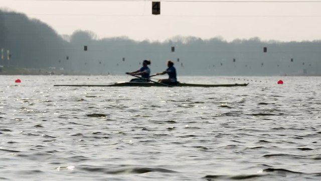 2 rowers, low angle shot over water
