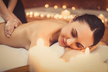 Obraz na płótnie Canvas Cheerful girl enjoying body treatment at spa