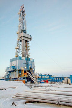 In the northern oil and gas field. Drilling rig. Before her lay the drill pipes.