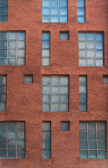 Naklejka premium Urban background. Architecture detail. Facade wall with tetris-style windows, made of glass blocks.
