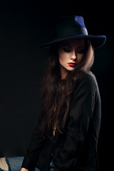 Expressive female makeup model posing in black shirt and elegant