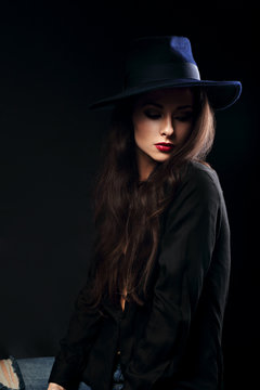 Expressive female makeup model posing in black shirt and elegant