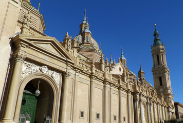 Fototapeta na wymiar Gorgeous domes and towers of Cathedral-Basilica of Our Lady of the Pillar against vivid blue sky, Zaragoza, Spain 