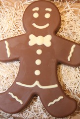 Figure  chocolate man decorated colored icing and being eaten. Holiday chocolate in shape of man for new year's day, christmas, winter holiday. 