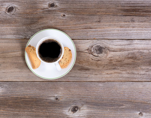 Dark coffee and biscuits for morning snack on rustic wood