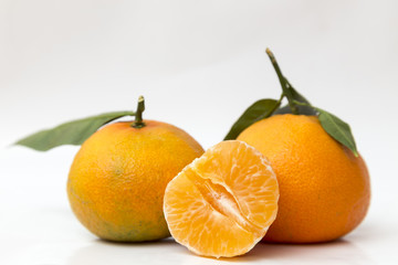 Two mandarins and half peeled