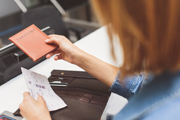 Girl handing over boarding pass to attendant