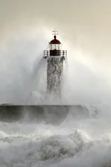 Poster Old lighthouse covered by stormy waves © Zacarias da Mata