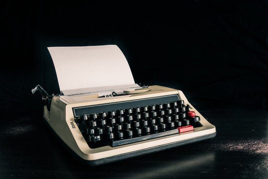 Vintage typewriter and a blank paper