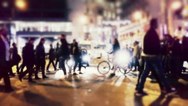 City pedestrians on winter night, cross street, slowmo 100p.Stabilized dolly shot of an anonymous crowd of pedestrians  crossing a busy intersection at night.No logos/faces visible.Commercial shot.