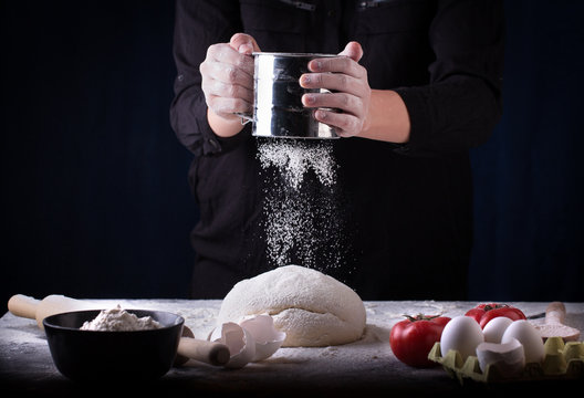Baker prepares the dough on table