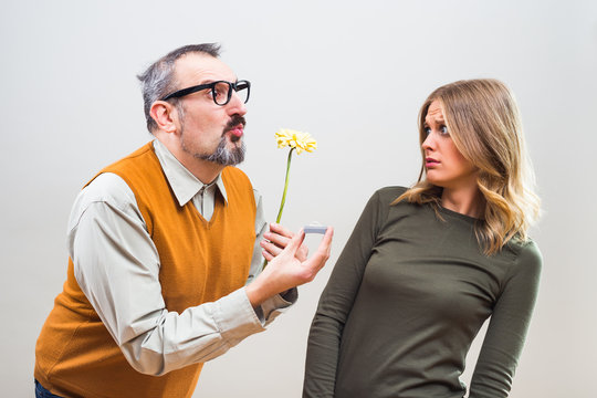 Nerdy man wants to marry to a beautiful woman but she is terrified, she doesn't want to marry.
