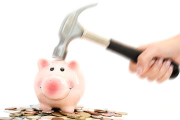 Piggy bank crashed or braked by hammer on money pile suggesting financial crisis © adrian_ilie825