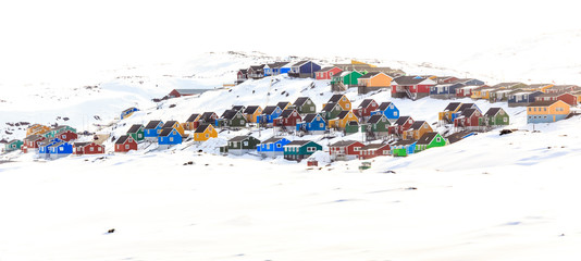 Colorful cabins on the hill covered in snow, Aasiaat city, Green © vadim.nefedov