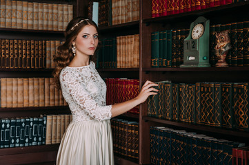 fashion studio photo of beautiful elegant bride with dark hair in luxurious wedding dress with headband