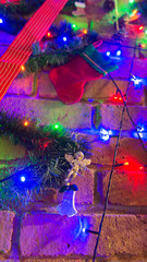 Fototapeta premium Christmas tree decoration over a brick chimney 