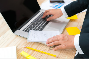 Business people using laptop and Financial charts at meeting off