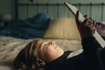 Sweet blondie girl playing on a Tablet. © santypan