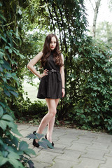 Beautiful young girl in black dress with long hair, super cute a