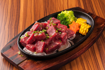Raw cutting beef with vegetables on wooden plate