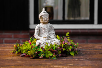 Buddha sitting among the flowers