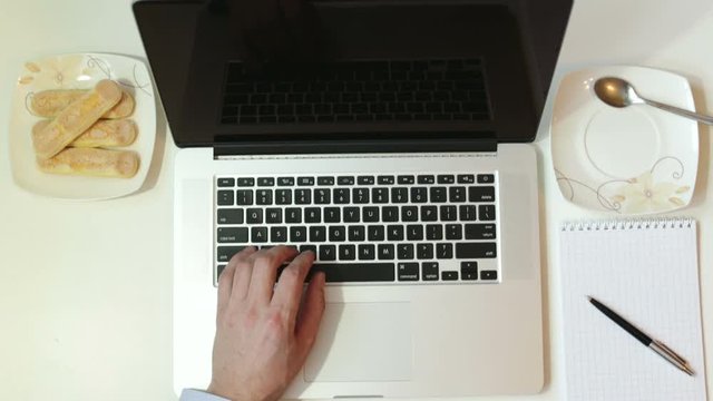 Businessman work on PC and drink coffee.