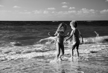 kids playing on the beach at sunset