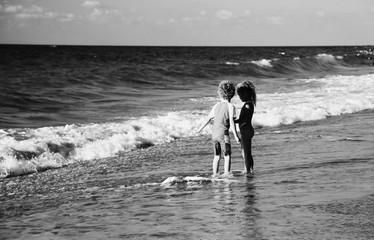 Fototapeta na wymiar kids playing on the beach at sunset