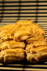 Rows of eclairs on a bamboo mat. Selective focus