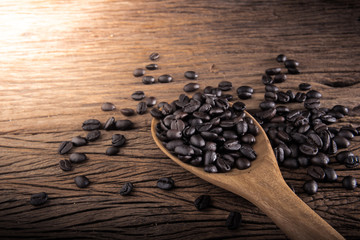 old wooden spoon with coffee beans