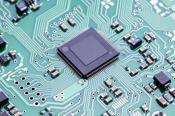 Close up printed circuit board of an electronic device with microelements.