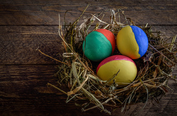 painted Easter eggs on wooden background