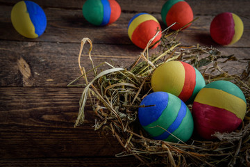 painted Easter eggs on wooden background