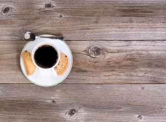 Freshly poured coffee and biscuits for snack on rustic wood