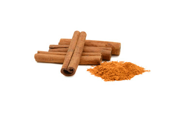 Cinnamon sticks with powder on white background