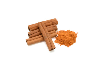 Cinnamon sticks with powder on white background