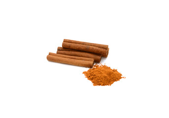 Cinnamon sticks with powder on white background