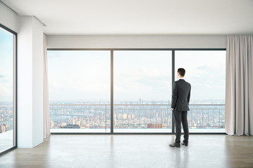 Man in room with city view