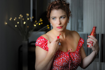 Glamour senior beauty  with button jewel holding a  sparkling wa