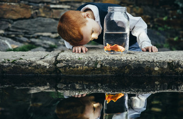 Little boy with aquarium decorative fish