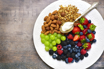 Concept of healthy breakfast : granola,nuts,fresh berries and yo