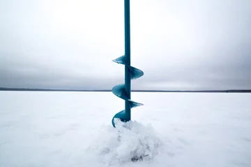 Zelfklevend Fotobehang Winter fishing on ice in the middle of a frozen lake © patho1ogy