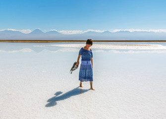 Lovely young woman in saline lagoon near San Pedro de Atacama - Chile